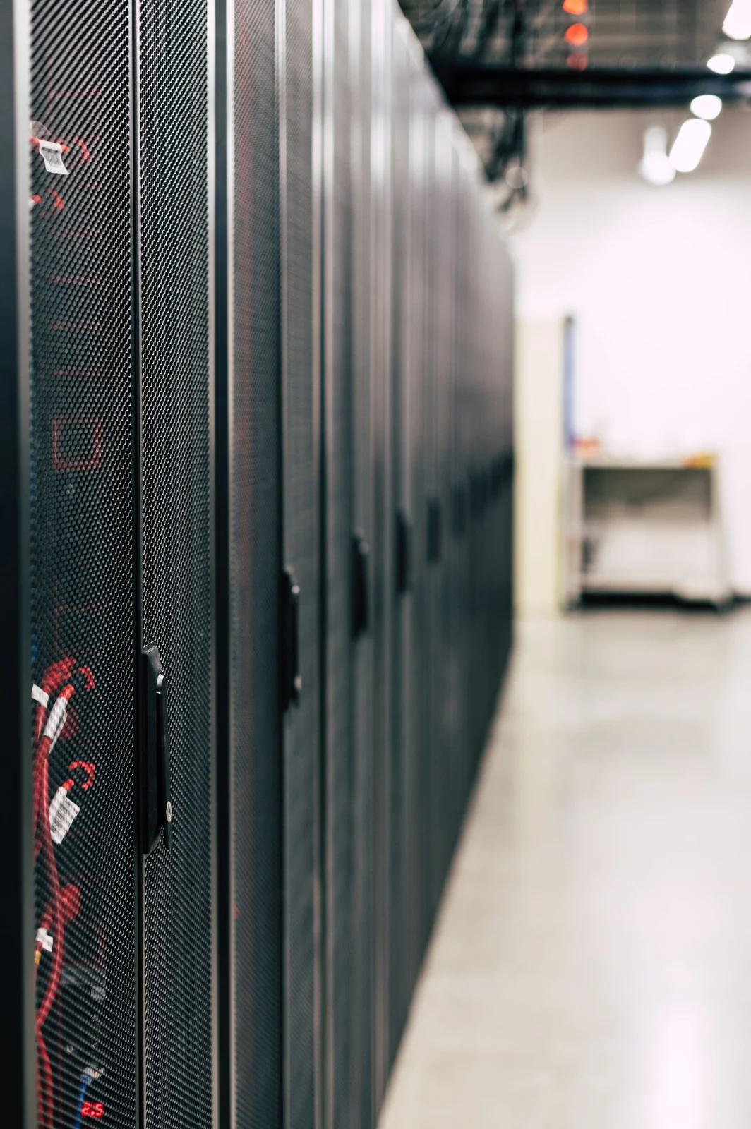 Row of black server cabinets inside a data center
